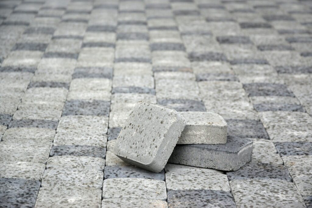 Small pile of gray walkway slabs lying in stack outdoors. Material for Paving Slabs